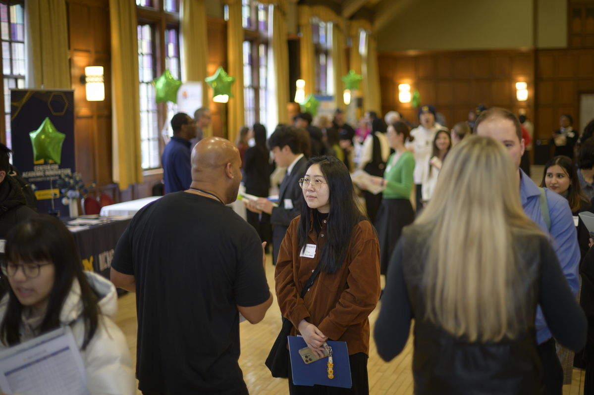 Students networking with recruiters at UMSI Career Fair